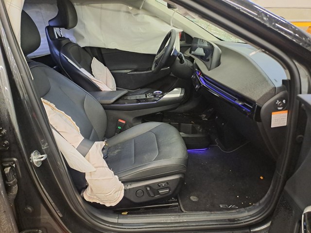 Auction photograph showing deployed airbags inside the Kia EV6